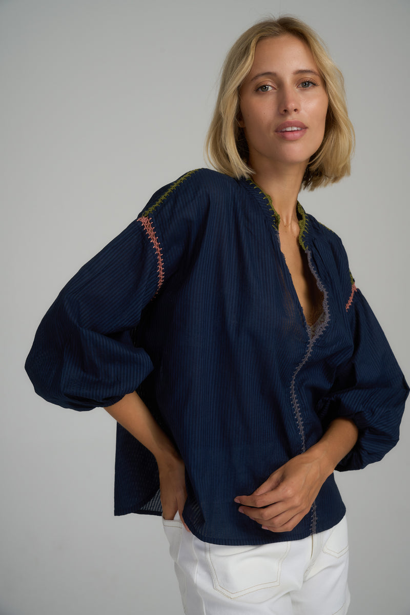 A woman in a navy blue cotton blouse in Australia