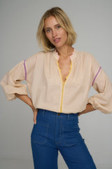 A model wearing a pink striped cotton blouse