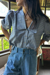 Blue check top with elasticated puff sleeves and styled with jeans