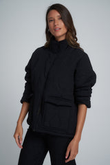 A model wearing a black winter jacket in Australia