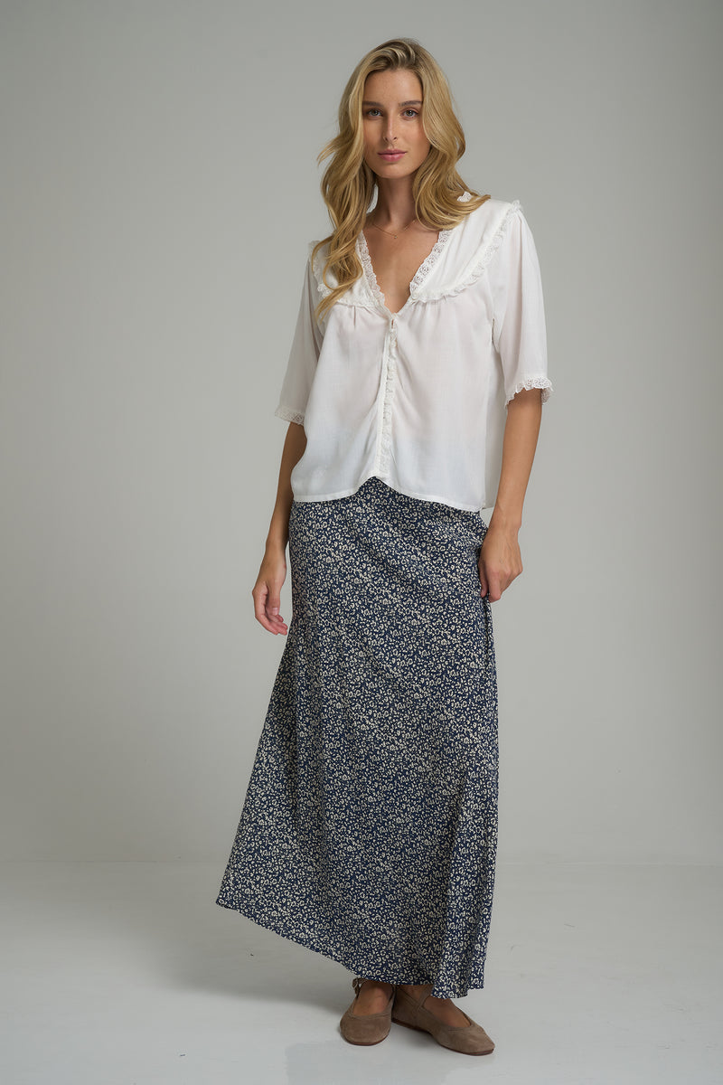 A woman wearing a navy floral skirt for winter