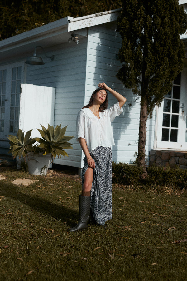 A model wearing a navy and white floral maxi skirt in Australia
