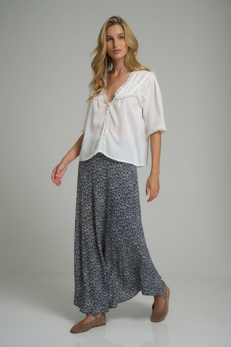 A model wearing a navy and white maxi skirt