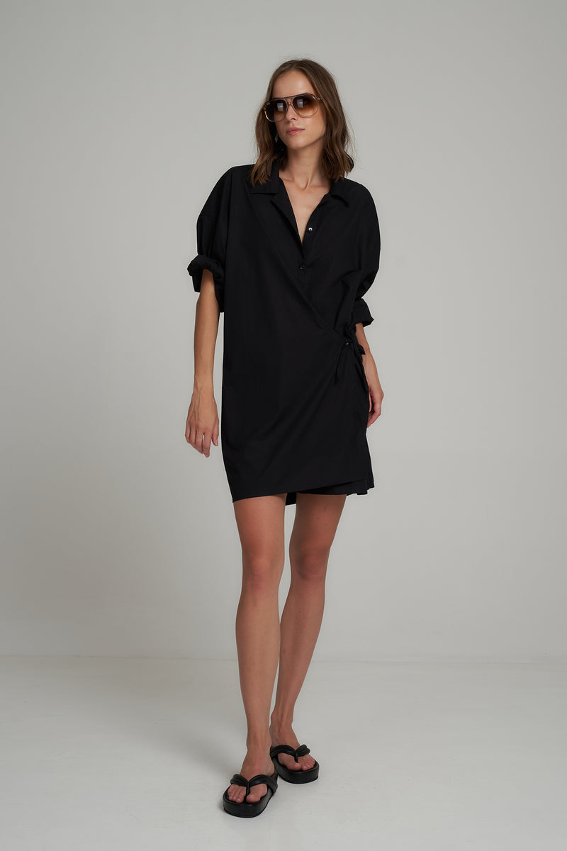A Model Wearing the Asymmetric Black Cotton Mini Dress by LILYA