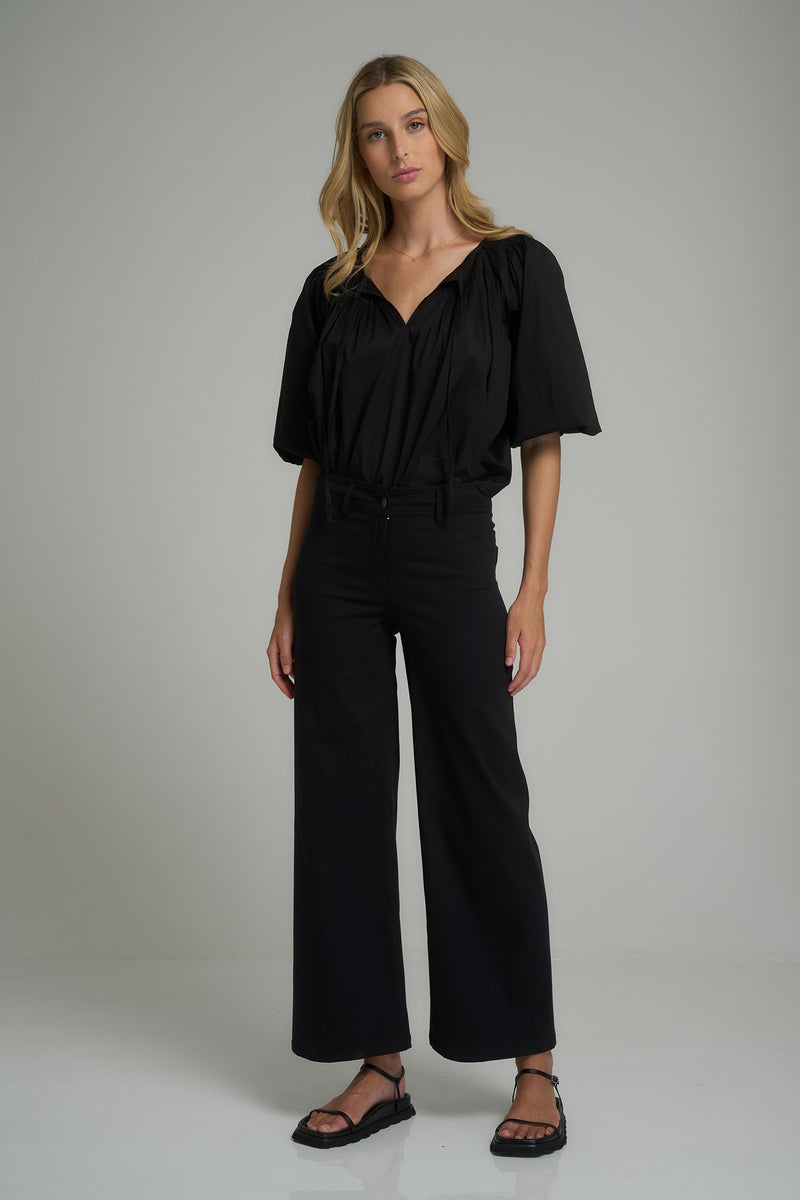 A model wearing versatile black cotton pants