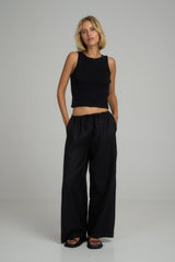 A model wearing casual black linen pants