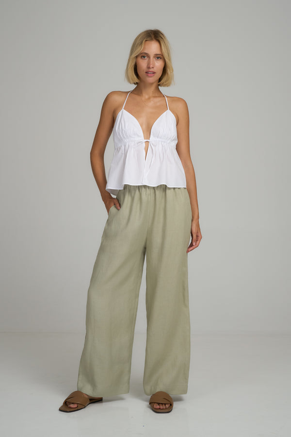 A model wearing green linen wide leg pants