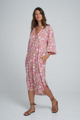 A Model Wearing a Pink/Brown Floral Maxi Dress
