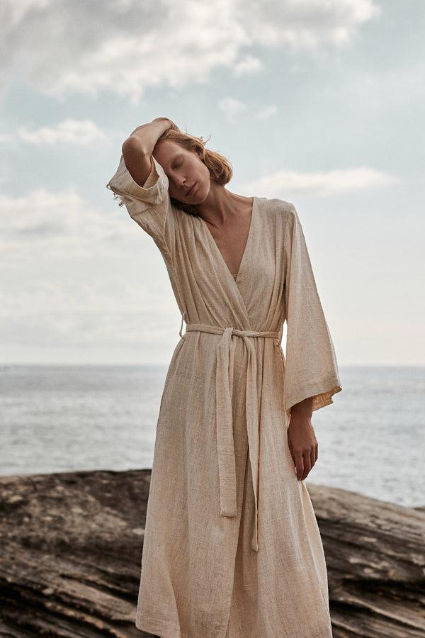 A Model Wearing a Long Cape Jacket in Natural Linen