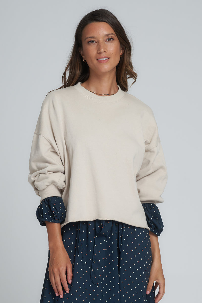 A model wearing a beige terry cotton sweatshirt