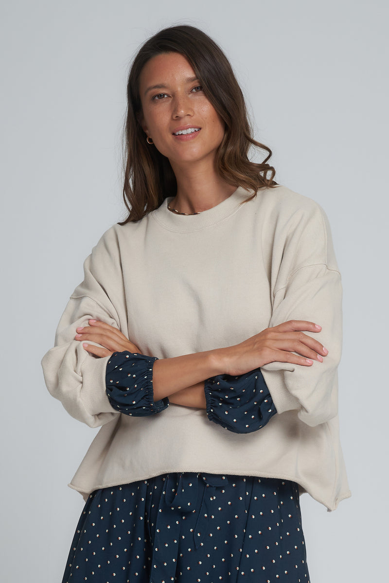 A model wearing a natural sweatshirt