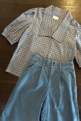 Flat lay of chambray denim look pants with pleated detail 