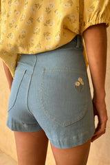 Back view of the Chamomile Short in Light Denim showing the embroidered Chamomile bloom.