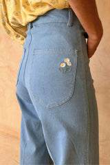 Back pocket floral embroidery detail on stretch cotton jeans. 