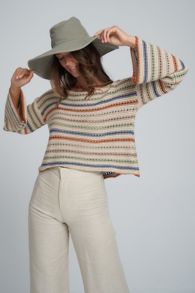 A Woman Wearing a Autumn Toned Striped Jumper