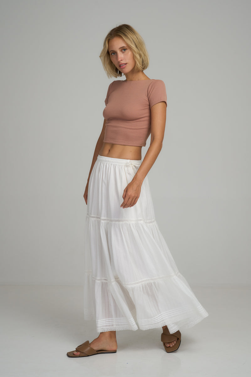 A model wearing a white cotton summer skirt