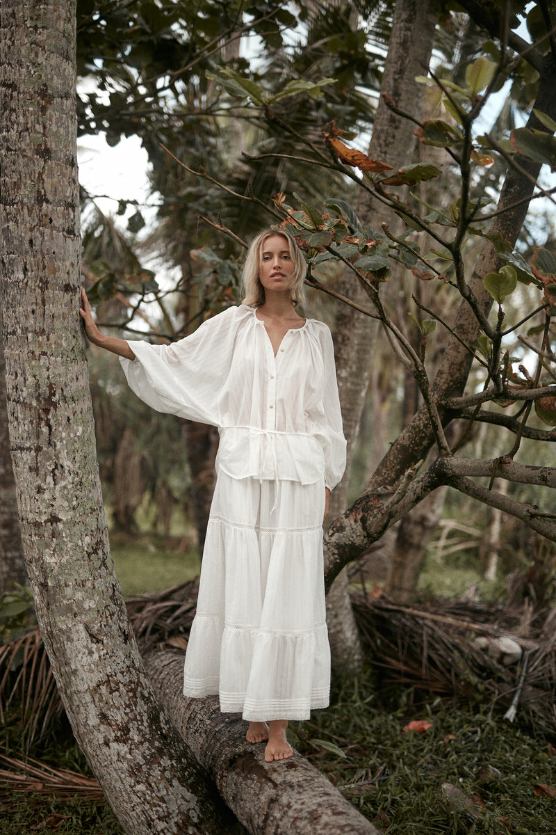 A woman wearing a white cotton summer skirt