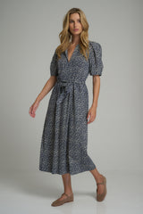 A model wearing a navy and white floral midi dress