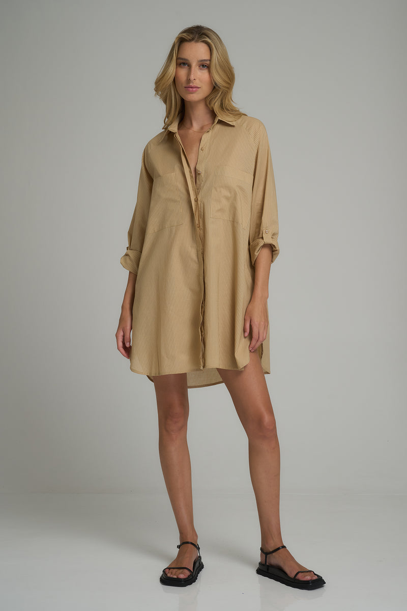 A woman wears a casual shirt dress for Autumn