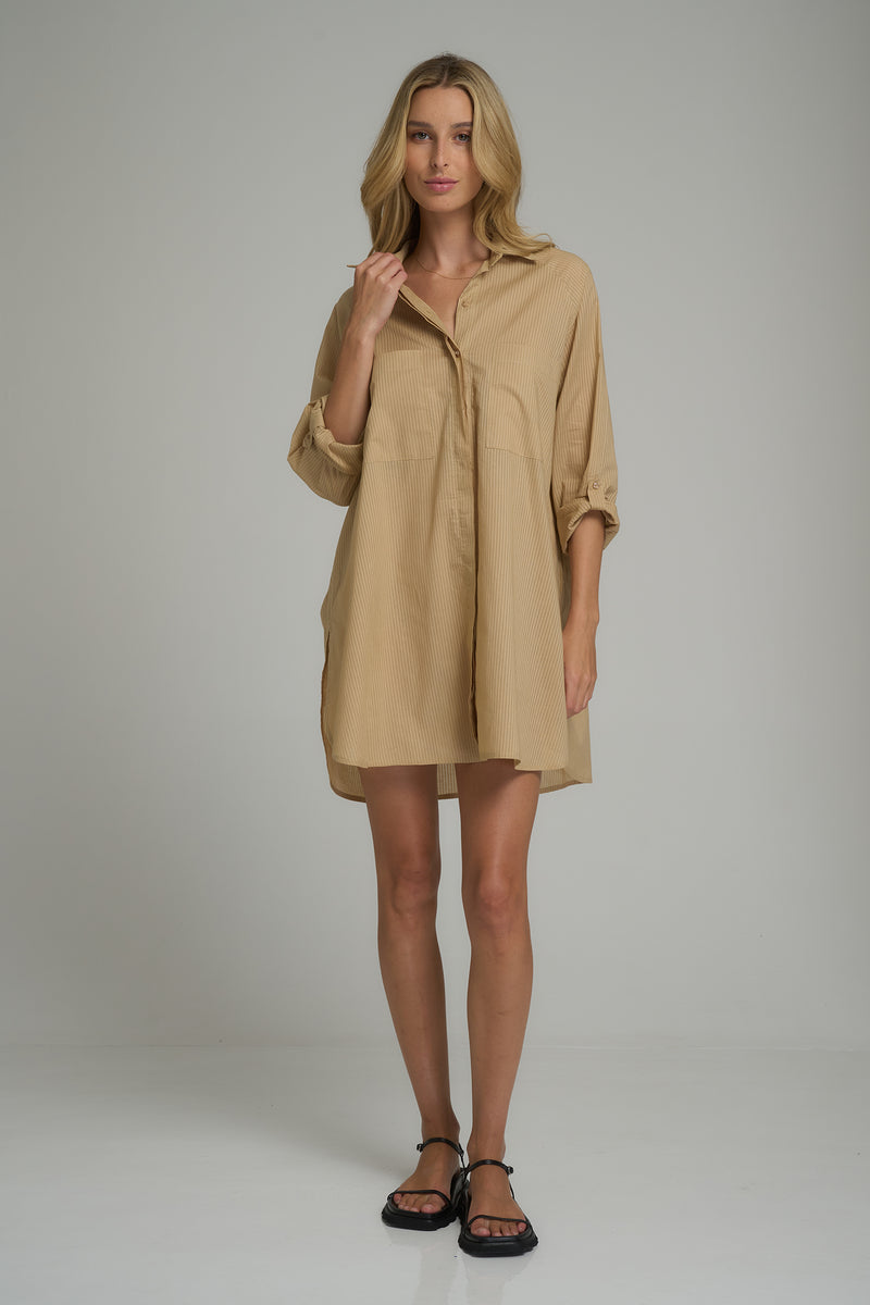 A model wearing a cotton shirt dress with long sleeves