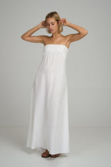 A model wearing a white strapless linen maxi dress