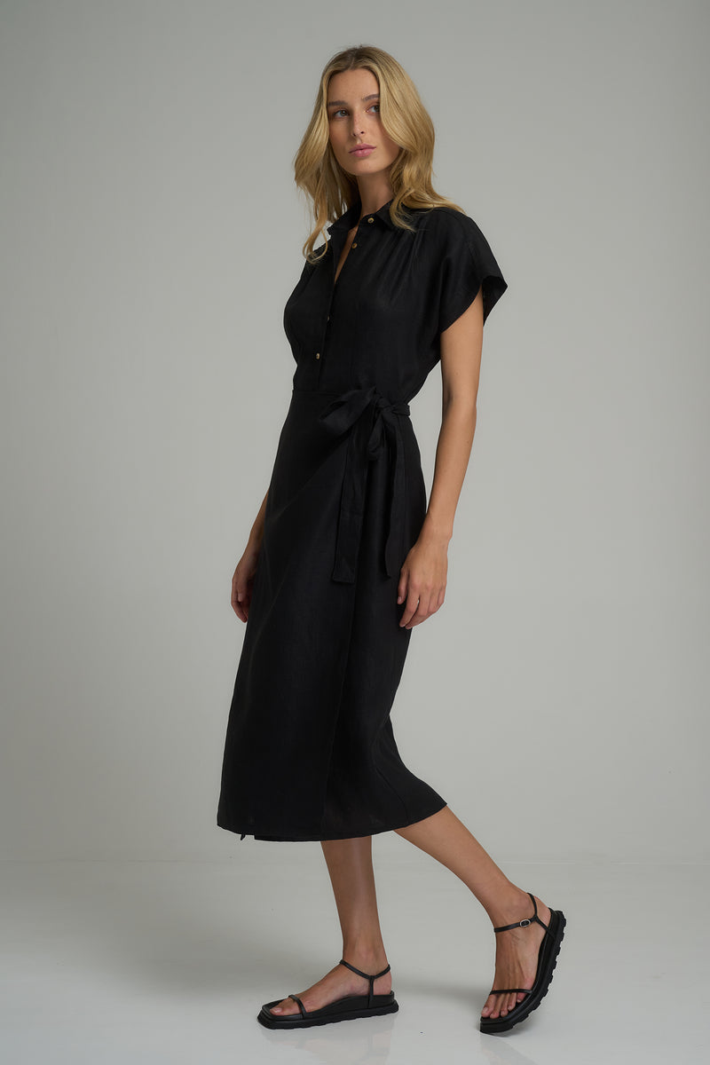 A model wearing a short sleeve black linen midi dress