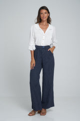 A model wearing high waisted 70's style linen pants