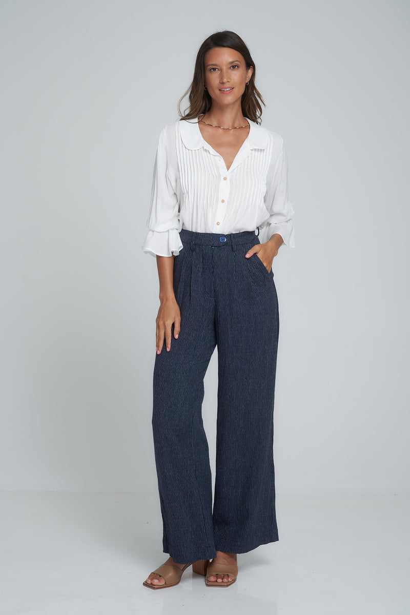 A model wearing high waisted 70's style linen pants