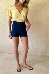 Model wearing the high-waisted stretch cotton denim shorts
