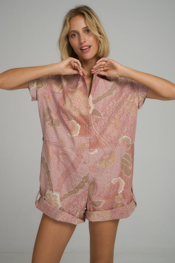 A model wearing a pink floral playsuit in Australia