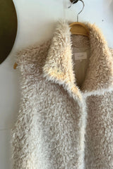 Beige fluffy vest hanging with soft faux fur for winter layering