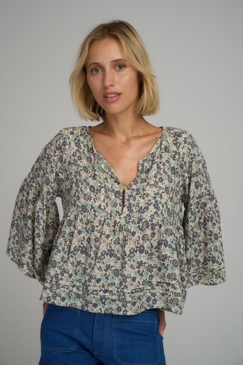 A model wearing a loose summer floral top