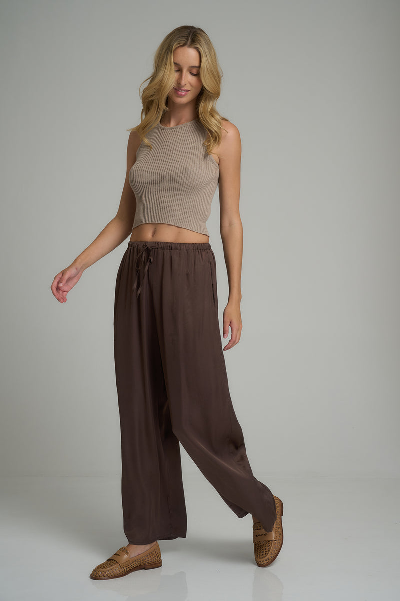 A model wearing soft dark brown wide leg pants