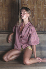 Model wears the sunset stripe flounce shirt