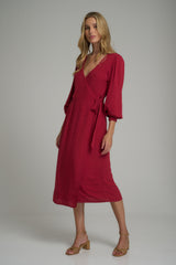 A model wearing a red midi wrap dress