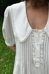 detail shot Gaia Dress button with pintucks and lace