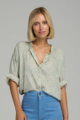 A model wearing a blue floral casual blouse