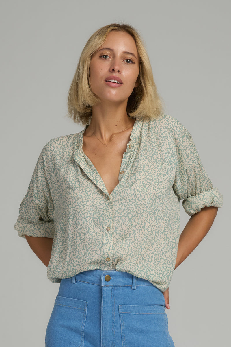 A model wearing a blue floral top in Australia