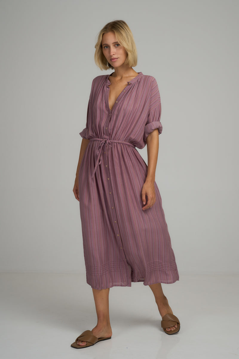 A woman wearing a casual lilac stripe cotton shirt dress