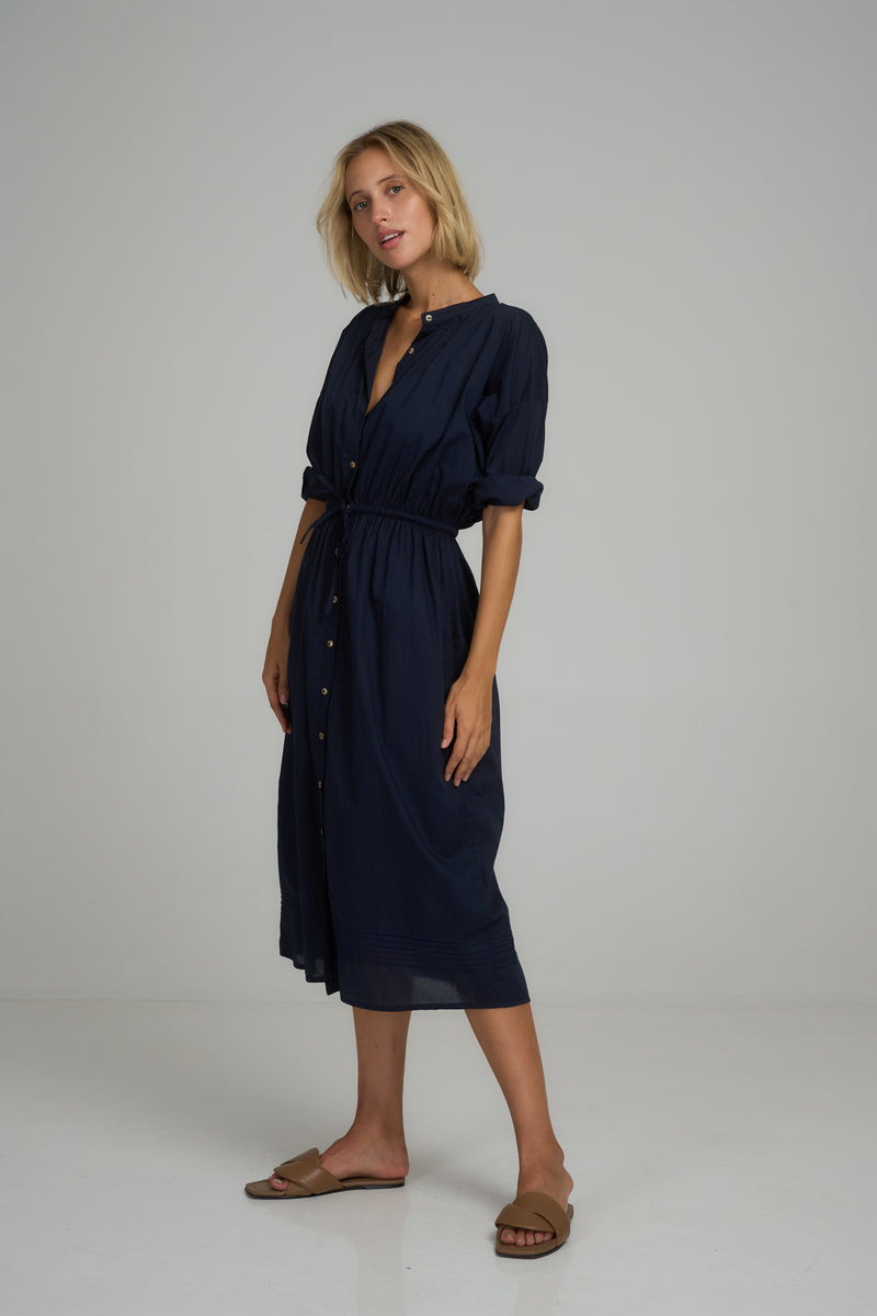 A model wearing a classic navy shirt dress