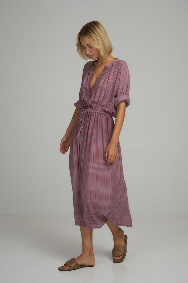 A model wearing the Ginger Shirt Dress in Lilac Stripe by LILYA