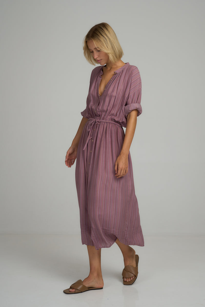 A model wearing the Ginger Shirt Dress in Lilac Stripe by LILYA