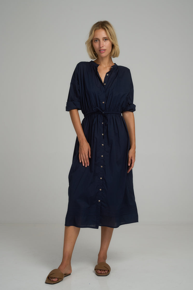 A model wearing a navy midi shirt dress