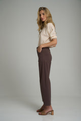 A side view of brown high rise cotton pants