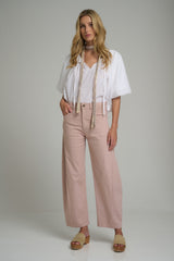 A model wearing pink high rise cotton pants