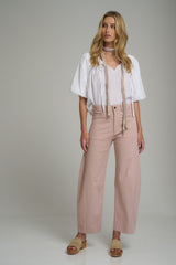 A model wearing light pink wide leg cotton pants in Australia