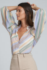 A Model Wearing a Pastel Striped Blouse
