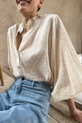 A woman wearing a natural cotton casual blouse