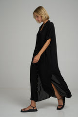 Side view of a classic black cotton maxi dress