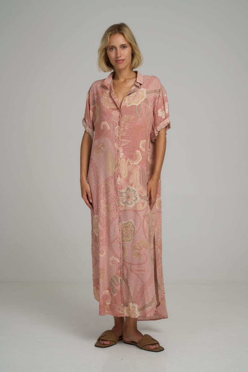 A model wearing a casual pink batik print maxi shirt dress